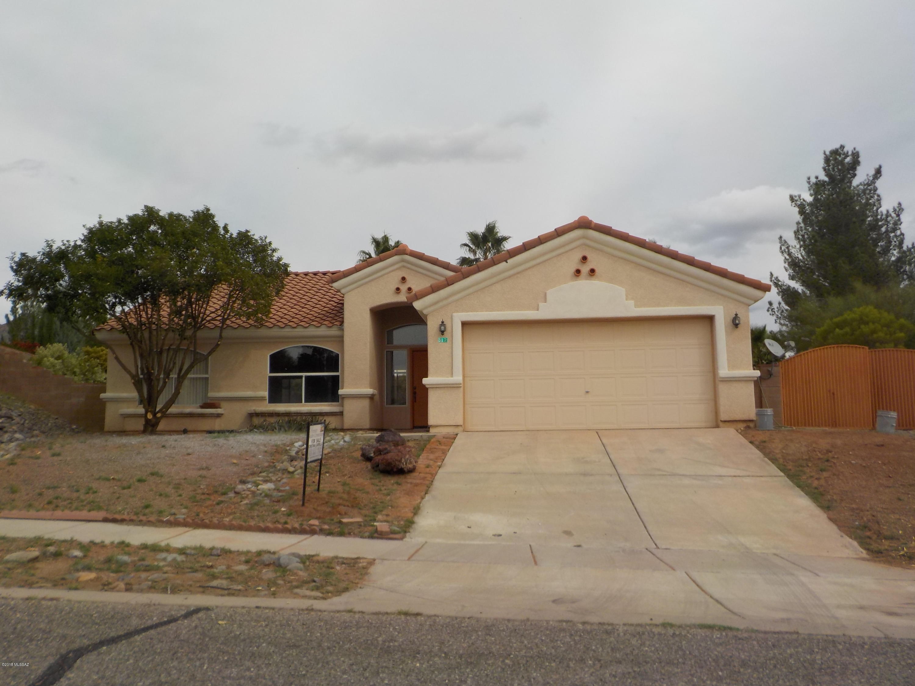52 Highland Circle Rio Rico, AZ 85648 - Photo 1 of 10 a front view of a house with a yard and garage