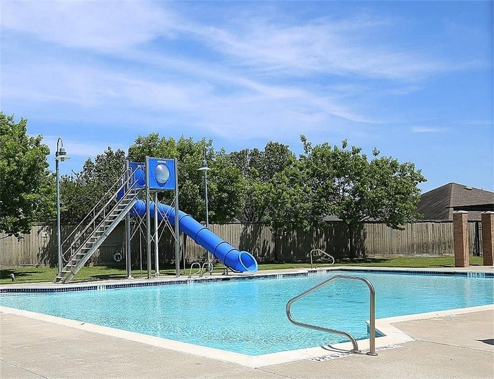 17223 Valhallah Way Houston, TX 77095 - Photo 14 of 14 a view of a swimming pool with a yard and wooden fence
