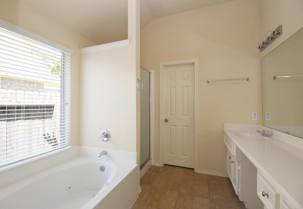 17223 Valhallah Way Houston, TX 77095 - Photo 10 of 14 a bathroom with a bathtub and a sink