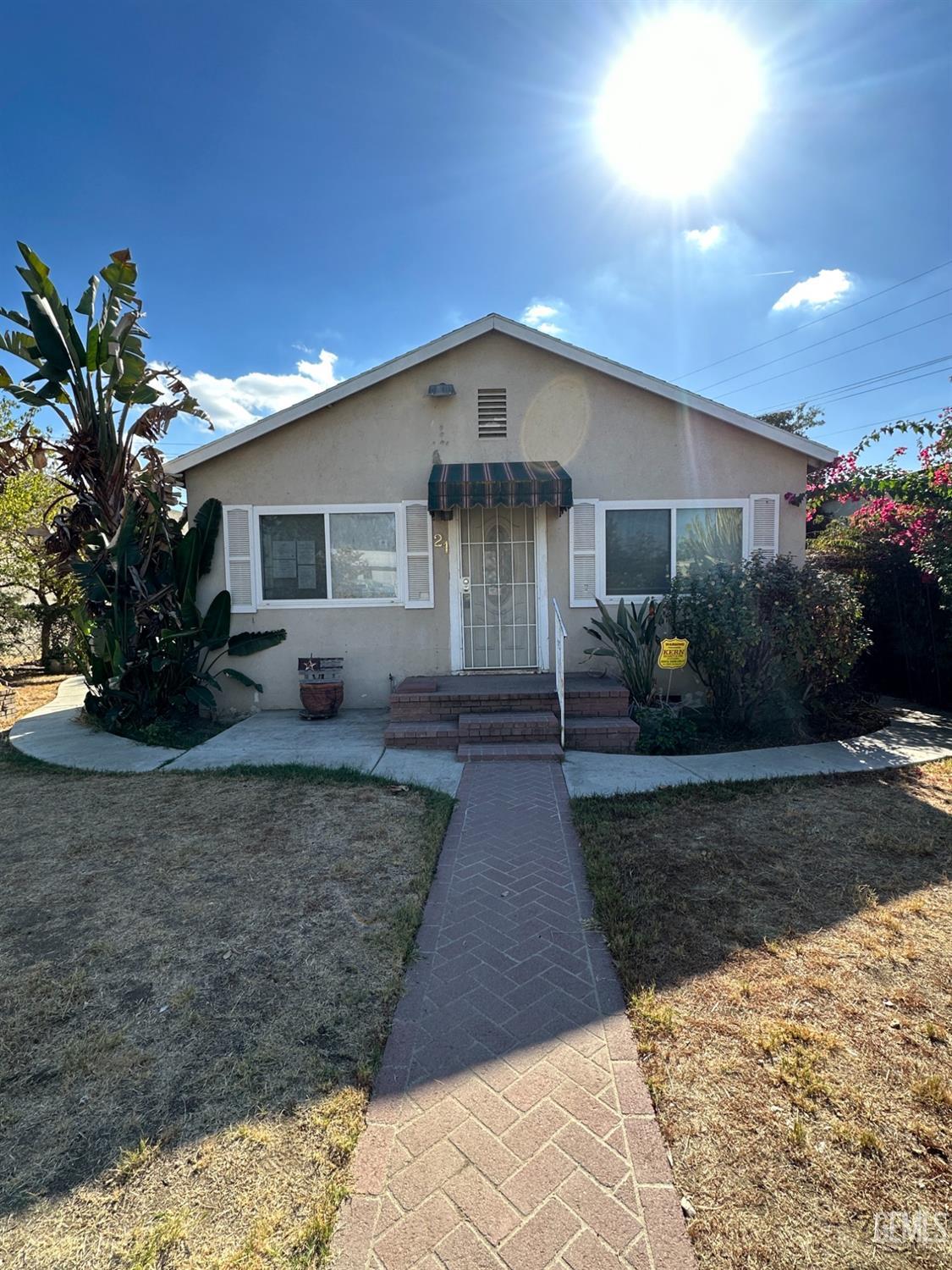 Undisclosed Address Bakersfield, CA 93305 - Photo 1 of 19 a front view of a house with garden