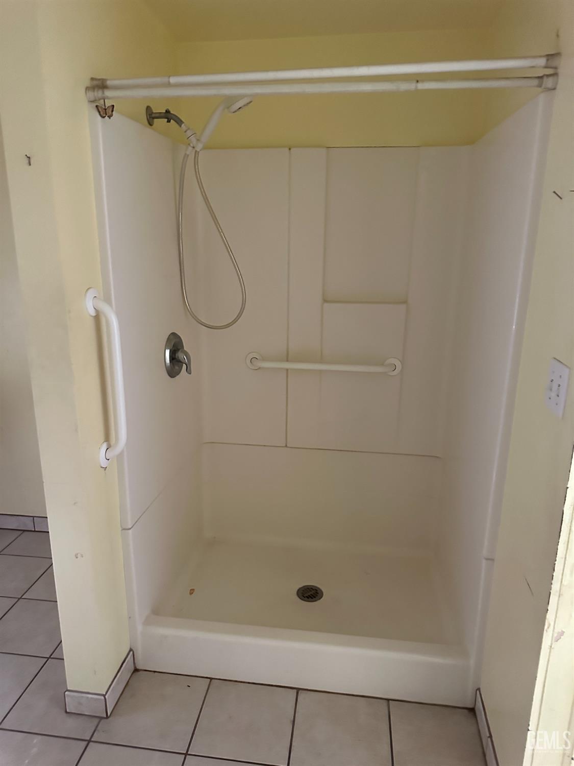 Undisclosed Address Bakersfield, CA 93305 - Photo 11 of 19 a bathroom with a glass door shower