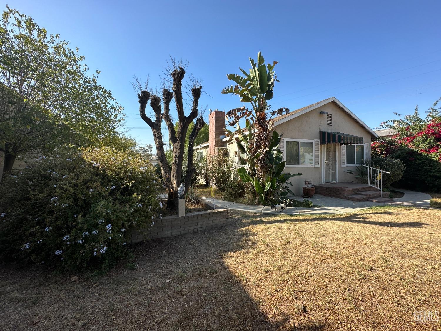 Undisclosed Address Bakersfield, CA 93305 - Photo 16 of 19 a front view of a house with garden