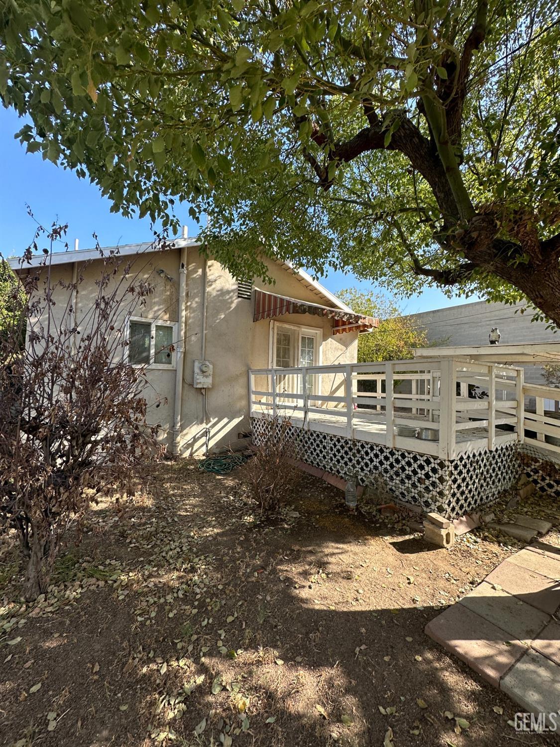 Undisclosed Address Bakersfield, CA 93305 - Photo 17 of 19 a front view of a house with a garden