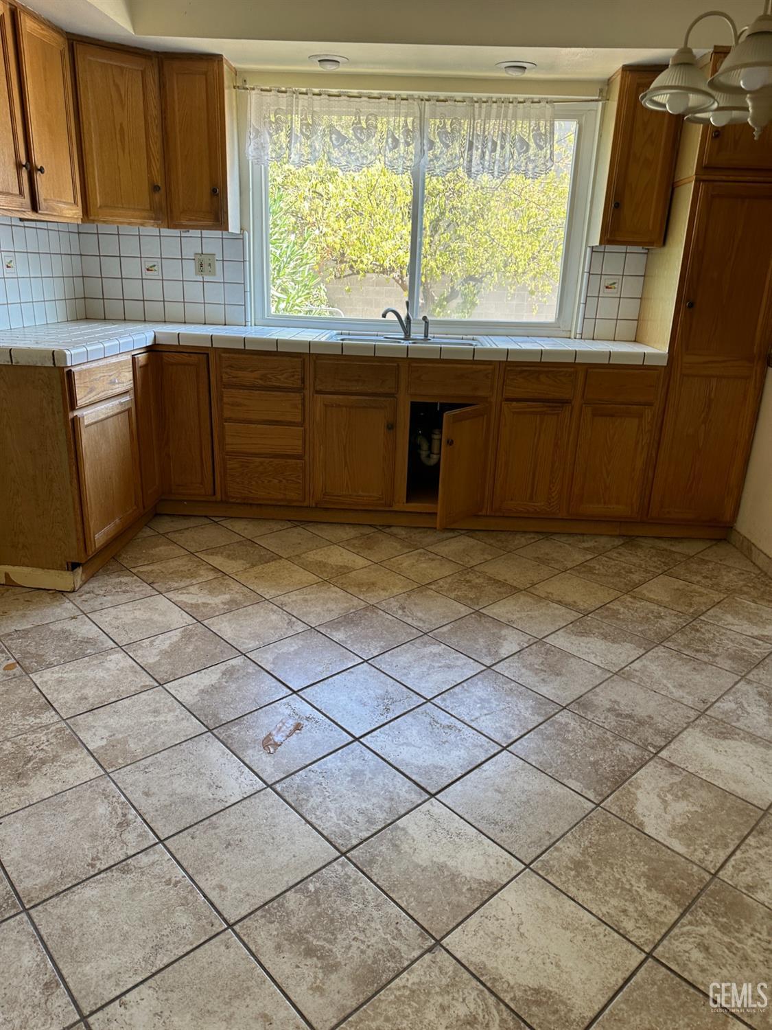 Undisclosed Address Bakersfield, CA 93305 - Photo 2 of 19 a view of a kitchen with a sink