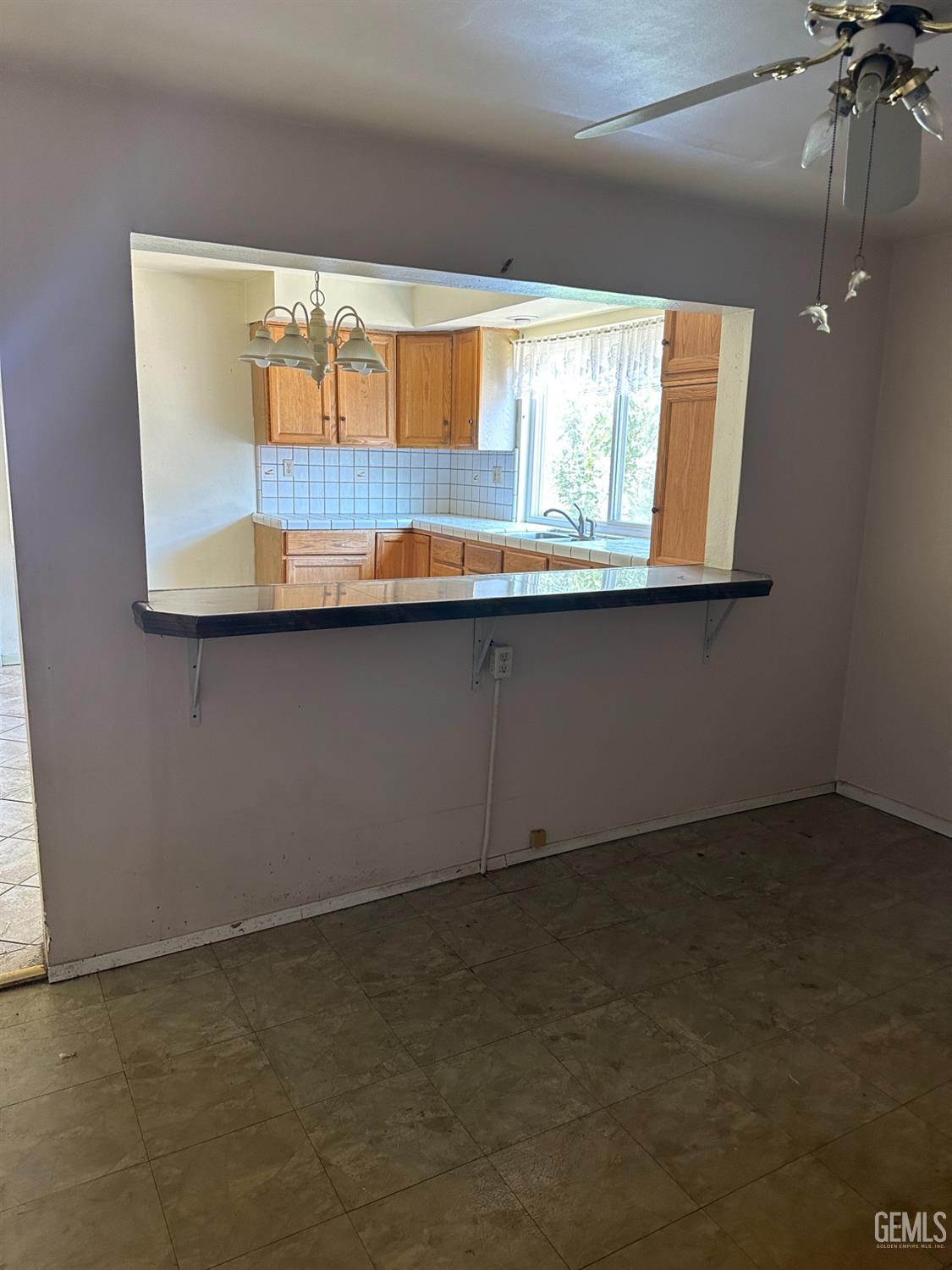 Undisclosed Address Bakersfield, CA 93305 - Photo 3 of 19 a kitchen with a sink window and cabinets