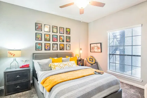 a bedroom with a bed and a window