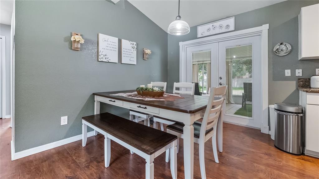 11746 Oswalt Road Clermont, FL 34711 - Photo 11 of 35 a kitchen with a table chairs and wooden floor