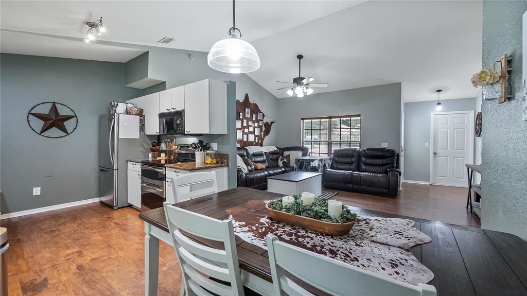 11746 Oswalt Road Clermont, FL 34711 - Photo 16 of 35 a kitchen with stainless steel appliances granite countertop a stove and a refrigerator