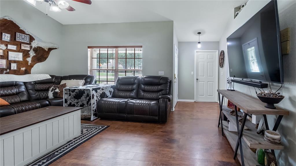 11746 Oswalt Road Clermont, FL 34711 - Photo 17 of 35 a living room with furniture and a flat screen tv