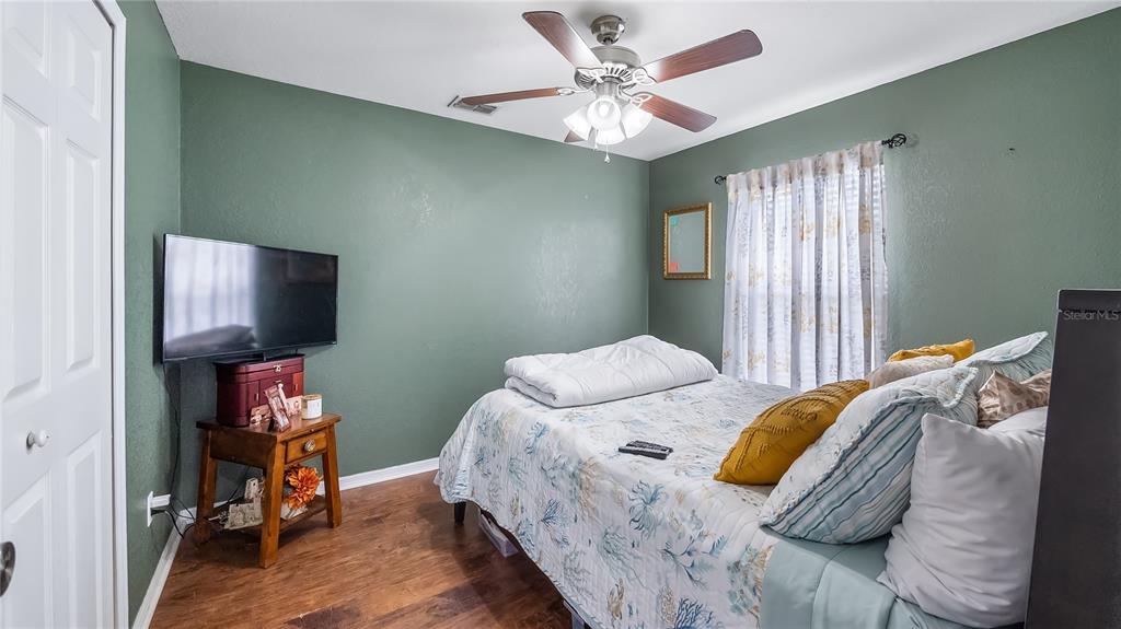 11746 Oswalt Road Clermont, FL 34711 - Photo 23 of 35 a bedroom with a bed and a flat screen tv