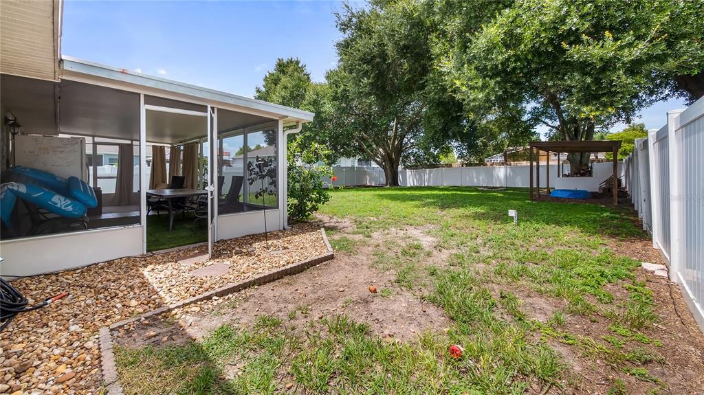 11746 Oswalt Road Clermont, FL 34711 - Photo 28 of 35 a view of a backyard with a garden and tree