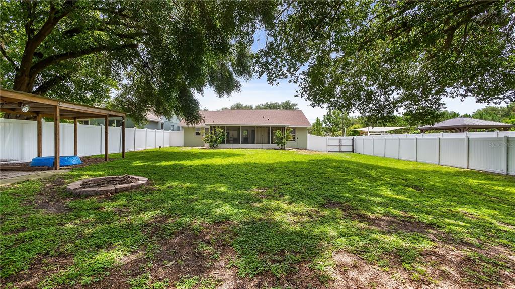 11746 Oswalt Road Clermont, FL 34711 - Photo 30 of 35 a view of a house with backyard and a tree