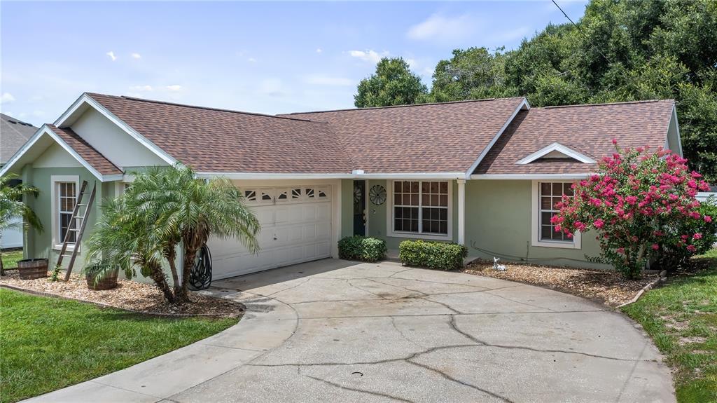11746 Oswalt Road Clermont, FL 34711 - Photo 4 of 35 a front view of a house with garden