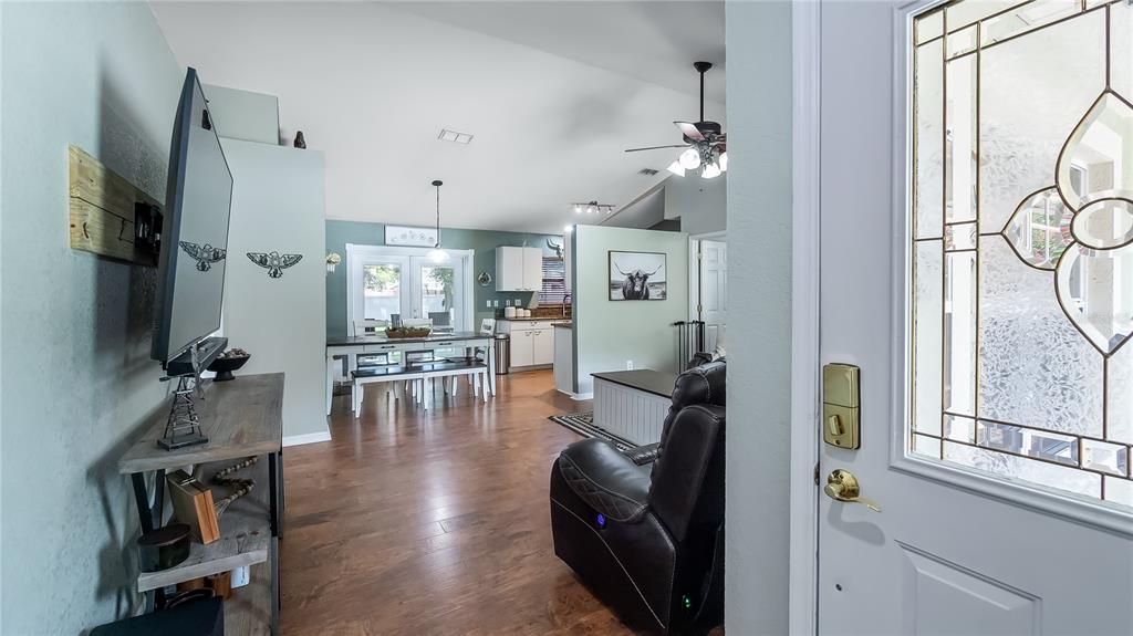 11746 Oswalt Road Clermont, FL 34711 - Photo 6 of 35 a living room with furniture a flat screen tv and a window