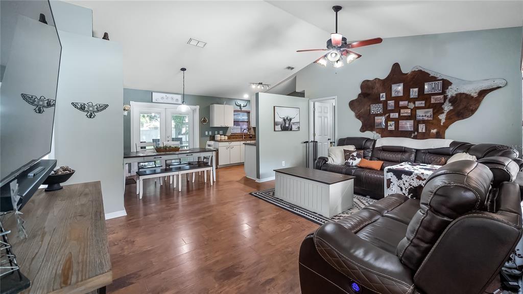 11746 Oswalt Road Clermont, FL 34711 - Photo 7 of 35 a living room with furniture and a wooden floor