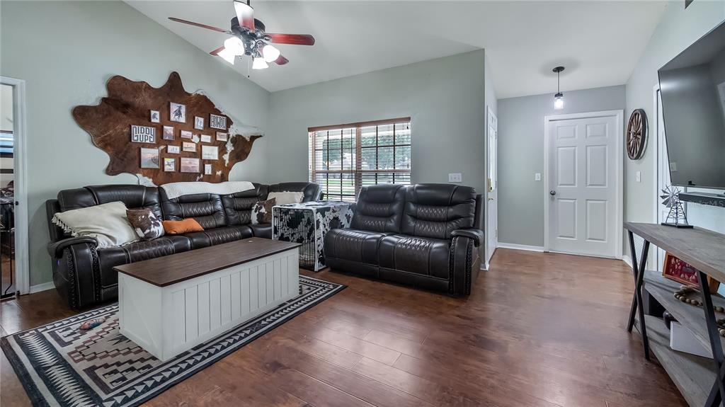 11746 Oswalt Road Clermont, FL 34711 - Photo 8 of 35 a living room with furniture and a flat screen tv