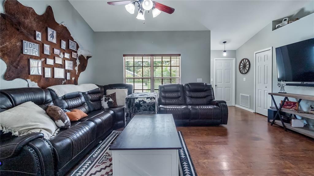 11746 Oswalt Road Clermont, FL 34711 - Photo 9 of 35 a living room with furniture and a flat screen tv