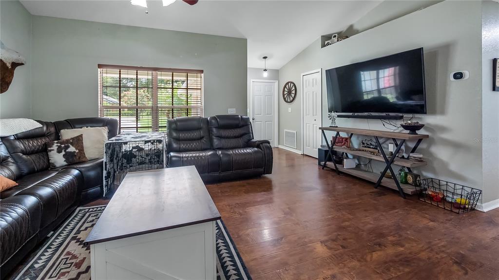 11746 Oswalt Road Clermont, FL 34711 - Photo 10 of 35 a living room with furniture and a flat screen tv