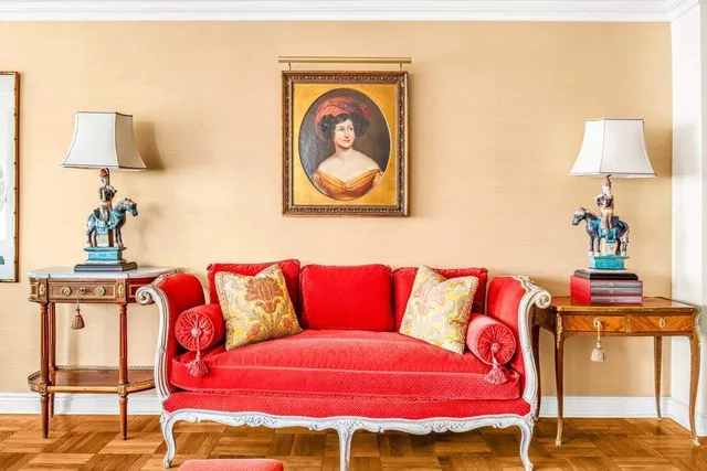 a living room with furniture a rug and white walls