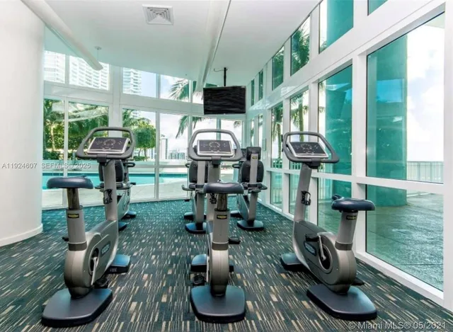a living room with furniture and a floor to ceiling window