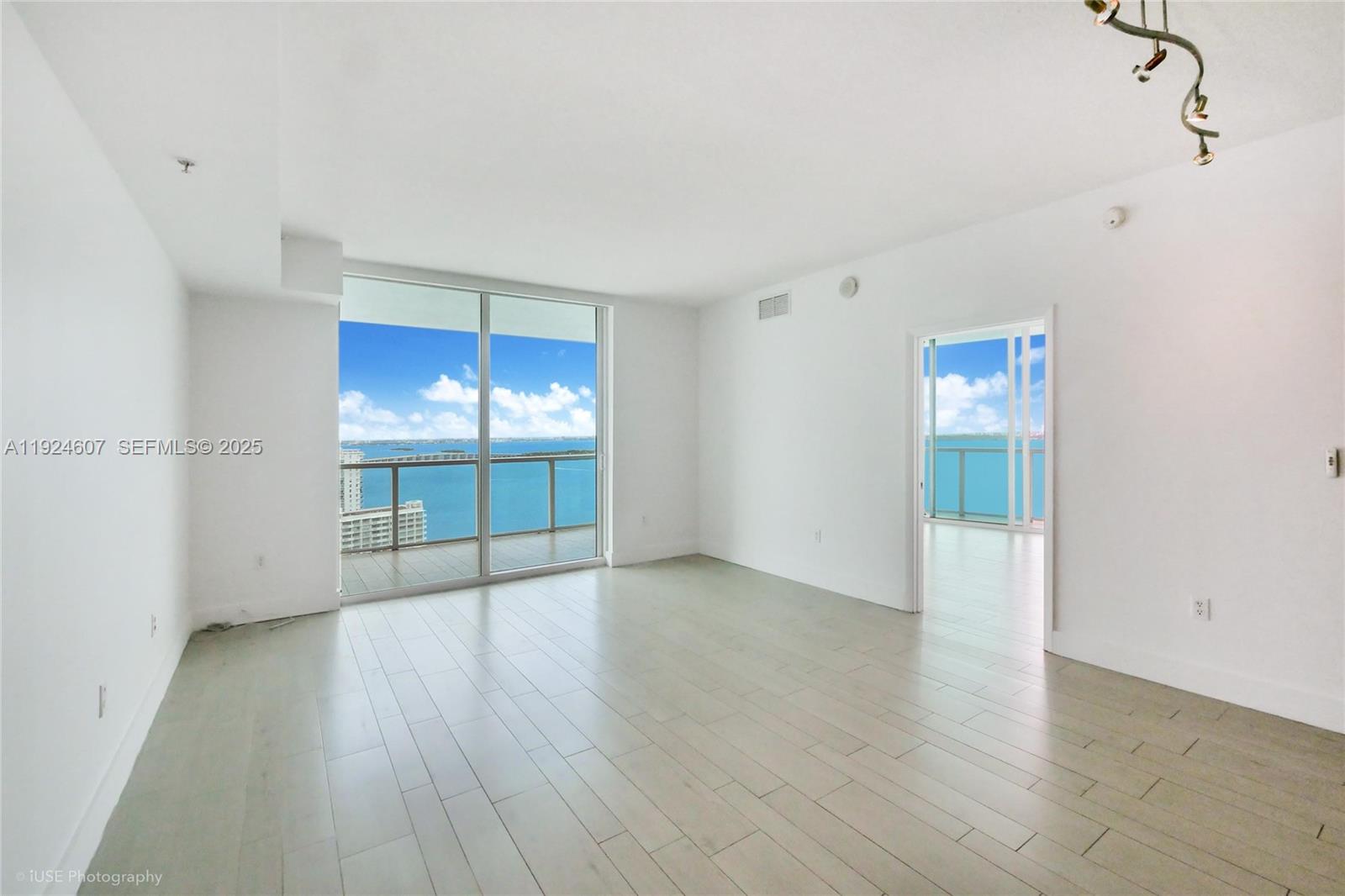 1900 North Bayshore Drive, Unit 2615 Miami, FL 33132 - Photo 2 of 17 an empty room with wooden floor and windows