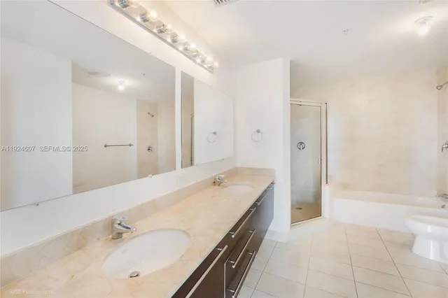 a spacious bathroom with a tub shower and sink