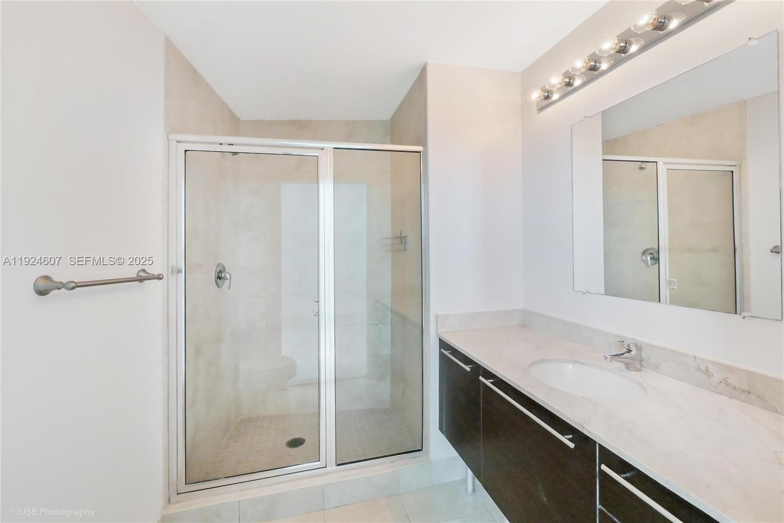 1900 North Bayshore Drive, Unit 2615 Miami, FL 33132 - Photo 6 of 17 a bathroom with a granite countertop sink a mirror and shower