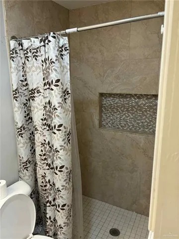 a bathroom with a shower toilet and a shower