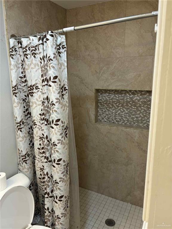 144 Redwood Road, Unit 2 Rio Grande City, TX 78582 - Photo 7 of 10 a bathroom with a shower toilet and a shower