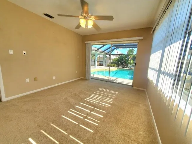 a view of an empty room with a fireplace and a window