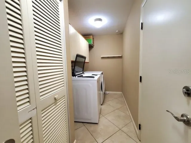 a view of a hallway with workspace and a window