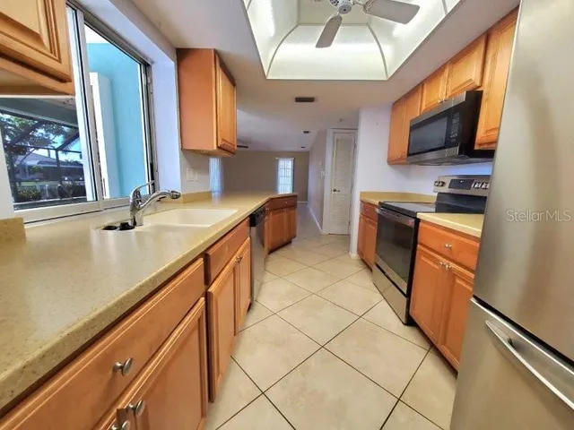 a kitchen with stainless steel appliances granite countertop a sink and a stove