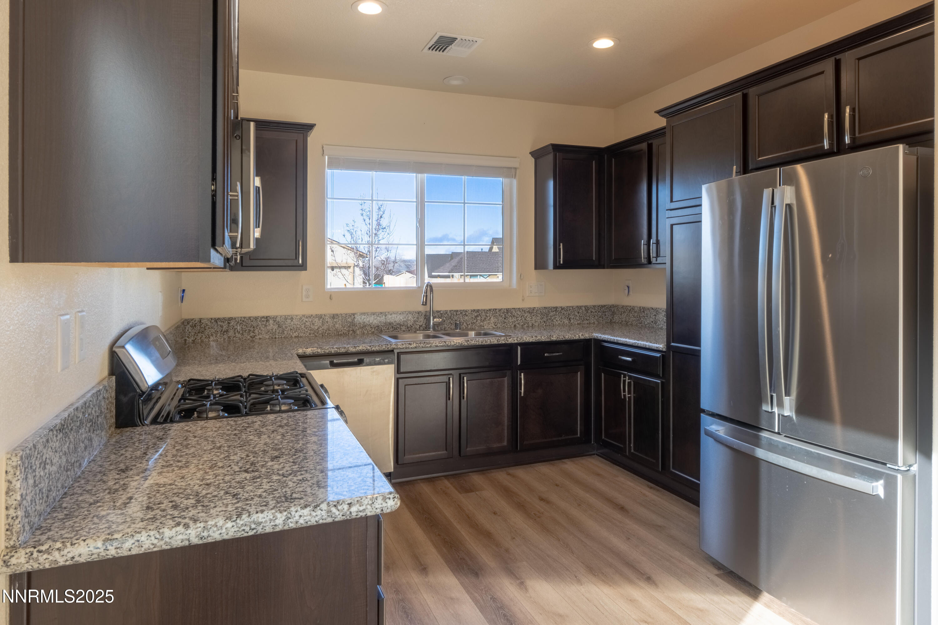 14524 Leiden Drive Reno, NV 89506 - Photo 13 of 33 a kitchen with granite countertop a refrigerator and a sink