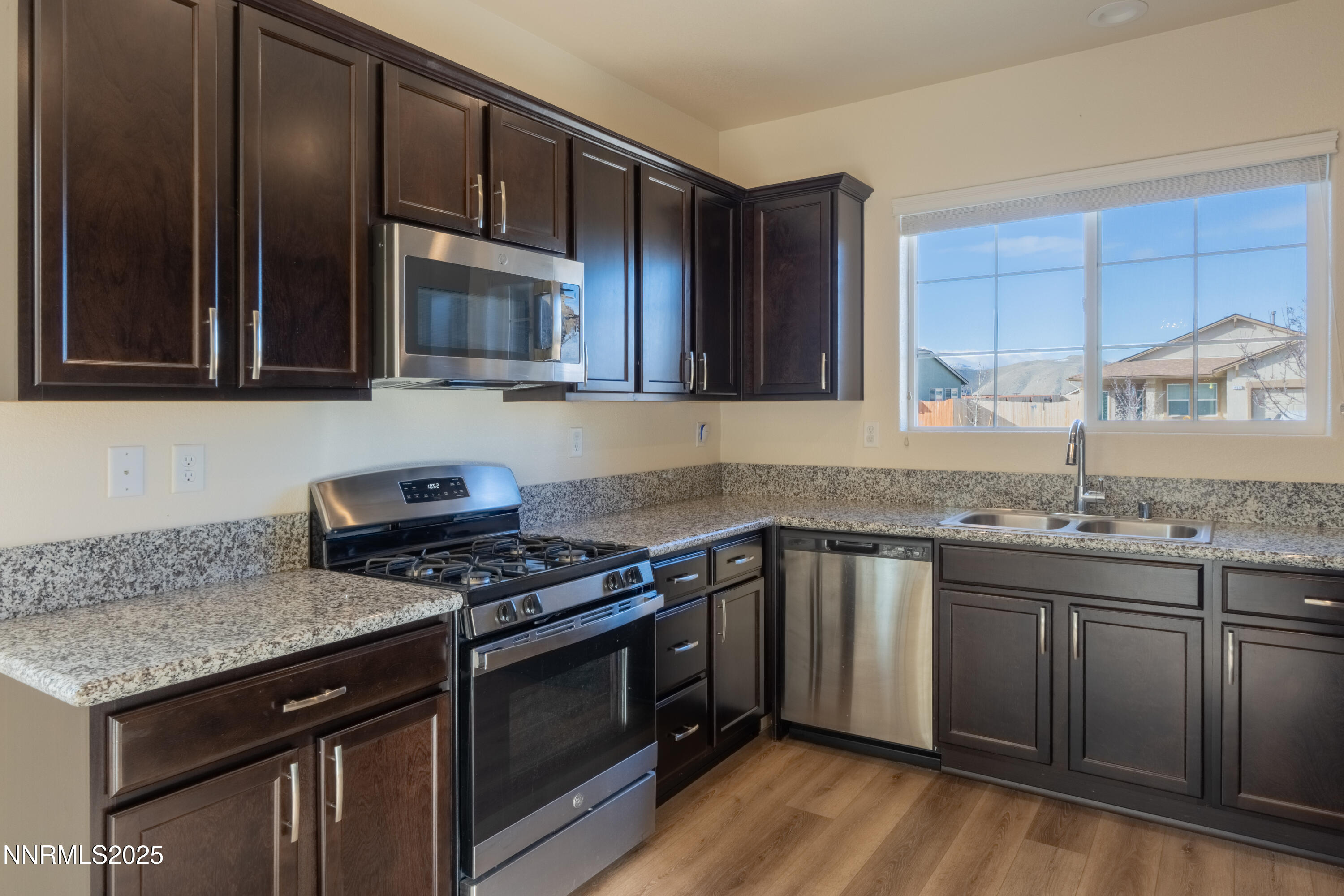 14524 Leiden Drive Reno, NV 89506 - Photo 10 of 33 a kitchen with granite countertop stainless steel appliances and wooden cabinets
