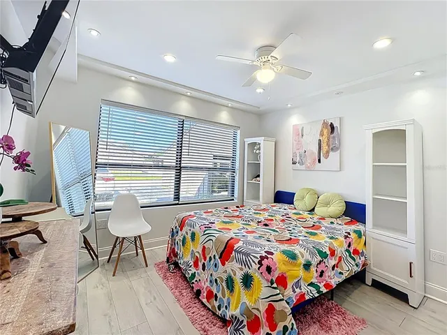 a bedroom with a bed and wooden floor