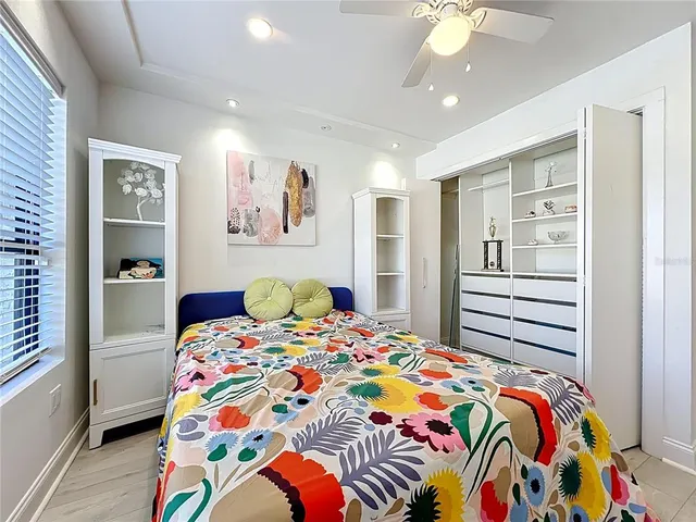 a bedroom with a bed and a painting on the wall