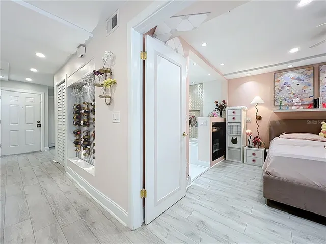 a view of a hallway with wooden floor and windows