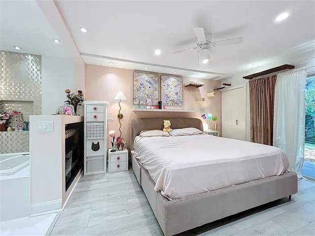 a bed room with a bed and a refrigerator