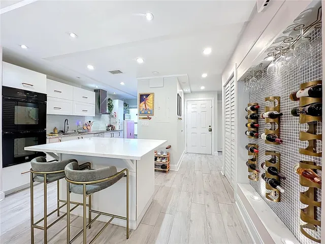 a kitchen with stainless steel appliances kitchen island granite countertop a sink and cabinets