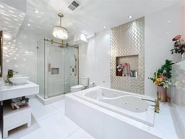 a bathroom with a tub a sink and a shower