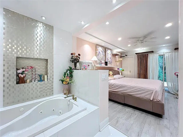 a bathroom with a tub sink and mirror