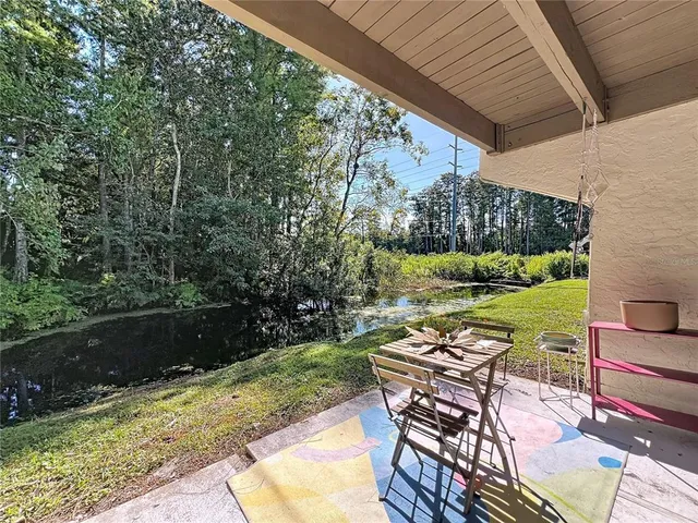 a view of a patio with table and chairs potted plants with wooden floor