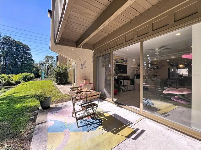 a building outdoor space with patio furniture and garden