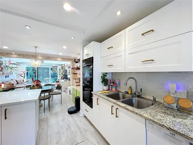 a kitchen with lots of counter top space and wooden floor