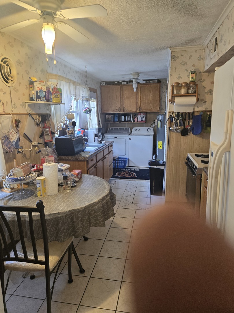 2038 Ruby Street Melrose Park, IL 60164 - Photo 7 of 13 a room with stainless steel appliances kitchen island granite countertop furniture and a kitchen view