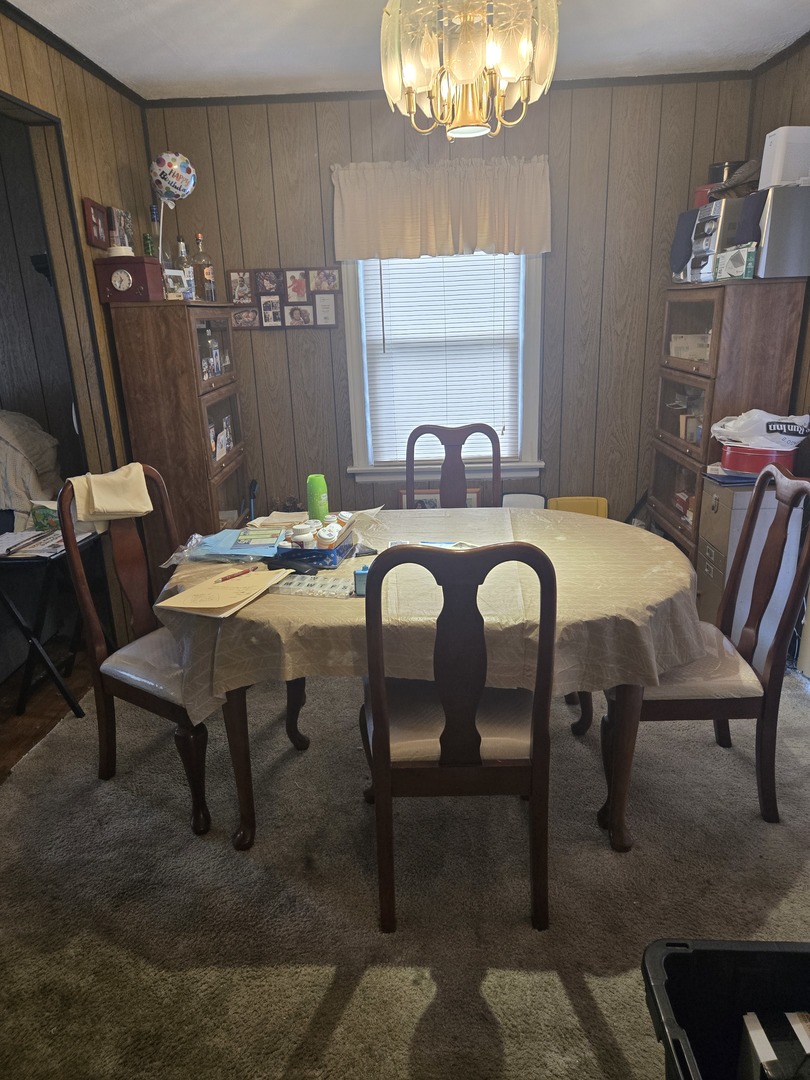 2038 Ruby Street Melrose Park, IL 60164 - Photo 8 of 13 a view of a dining room with furniture and a chandelier