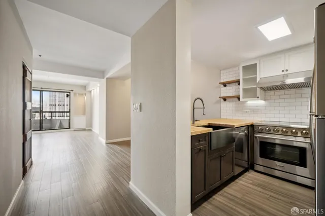 a kitchen with stainless steel appliances granite countertop a stove and a refrigerator
