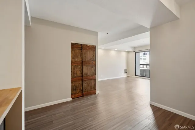 wooden floor in an empty room with a window