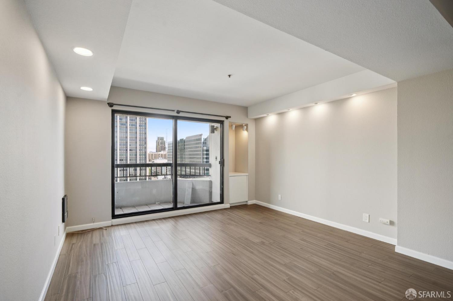 601 Van Ness Avenue, Unit 812 San Francisco, CA 94102 - Photo 13 of 33 wooden floor in an empty room with a window