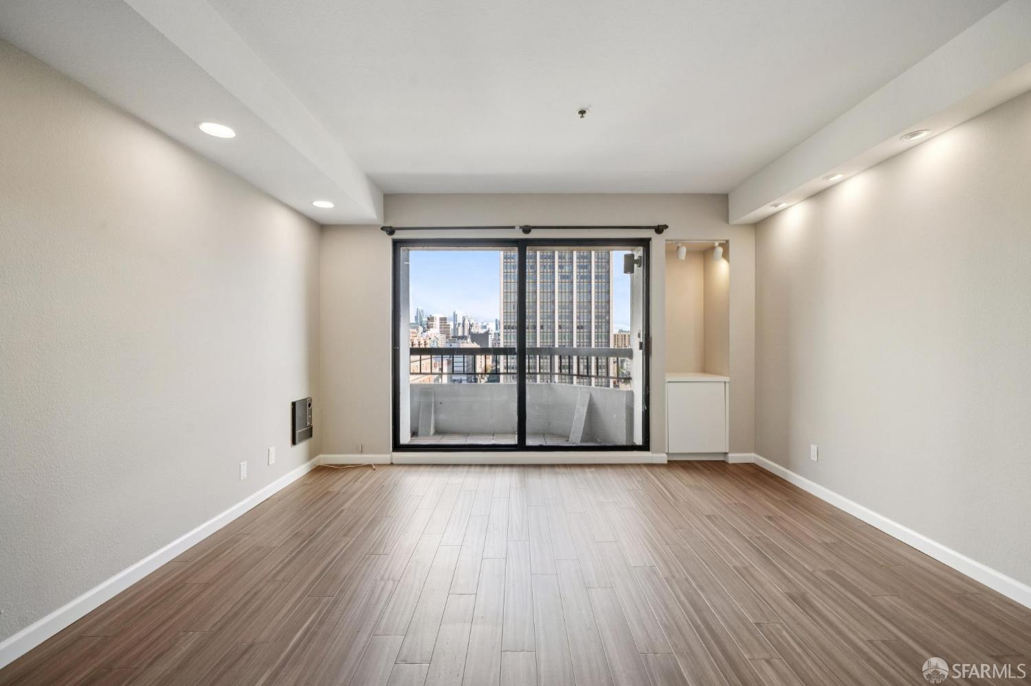 601 Van Ness Avenue, Unit 812 San Francisco, CA 94102 - Photo 14 of 33 a view of an empty room with wooden floor and a window
